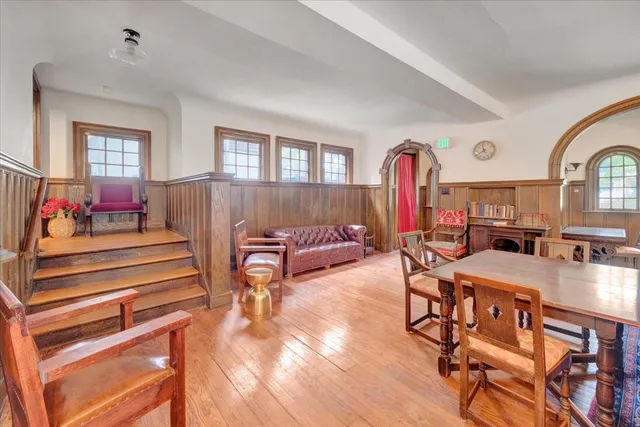 a living room with furniture fireplace and window