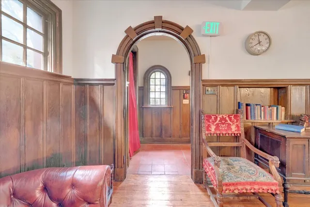 a view of a livingroom with furniture staircase and front door