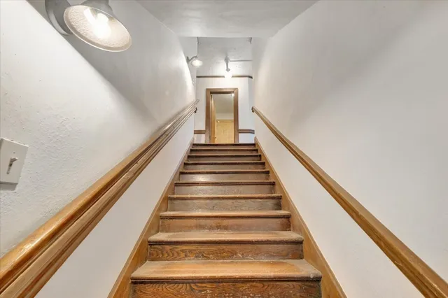 a hallway with wooden floor and furniture