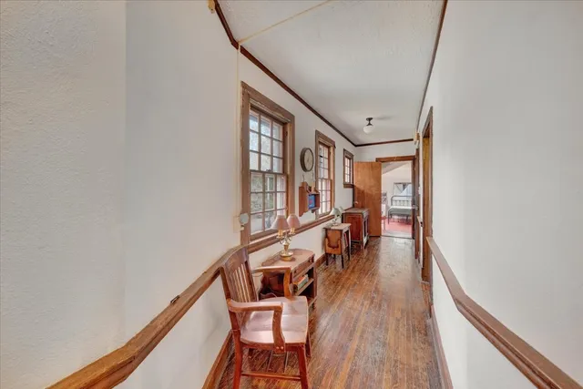 a bedroom with furniture and a wooden floor