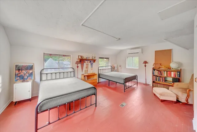 a very nice looking room with wooden floor and furniture