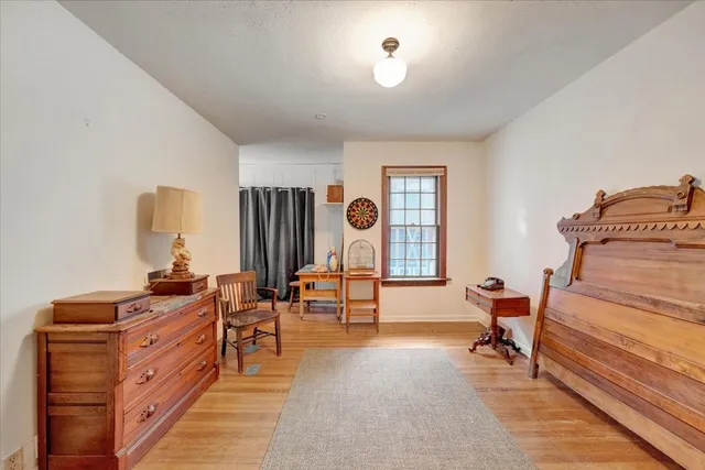 a bedroom with a large bed and a chandelier
