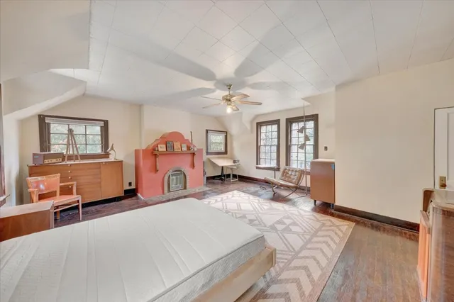 a bedroom with furniture and large windows