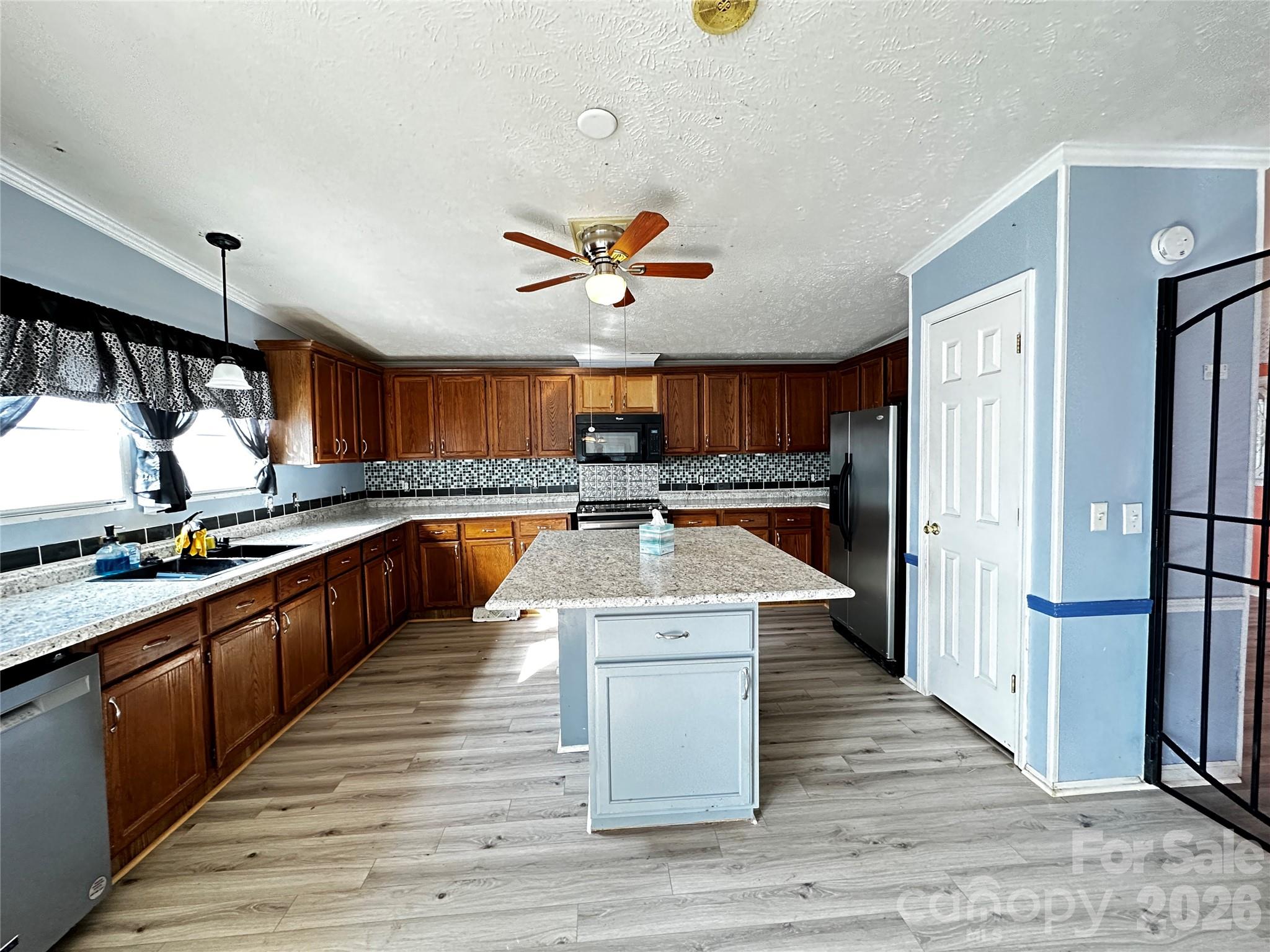 7447 Highway 64, Unit 2 Morganton, NC 28655 - Photo 11 of 27 a large kitchen with stainless steel appliances a stove and a refrigerator
