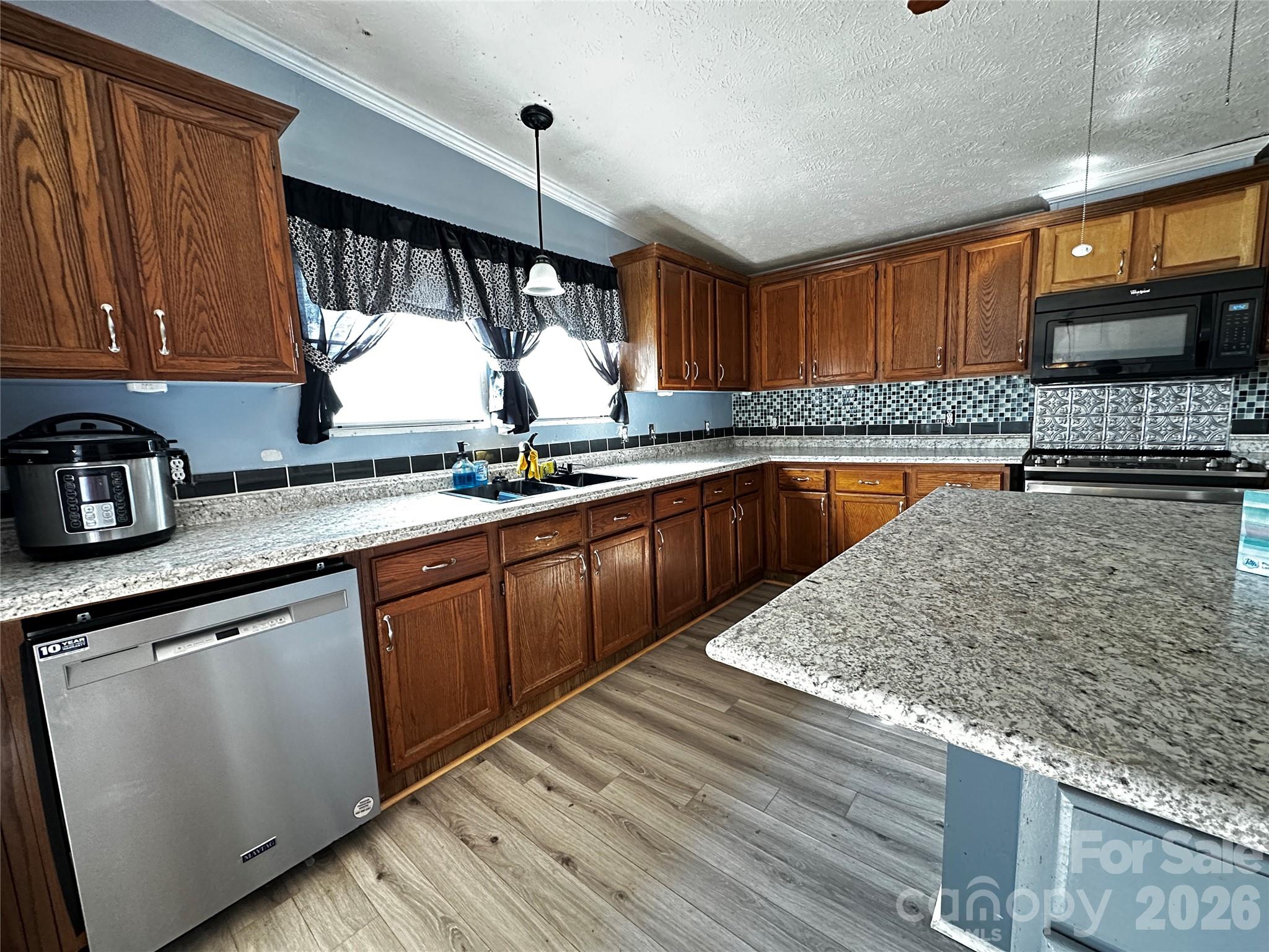 7447 Highway 64, Unit 2 Morganton, NC 28655 - Photo 12 of 27 a kitchen with stainless steel appliances granite countertop a sink stove and cabinets