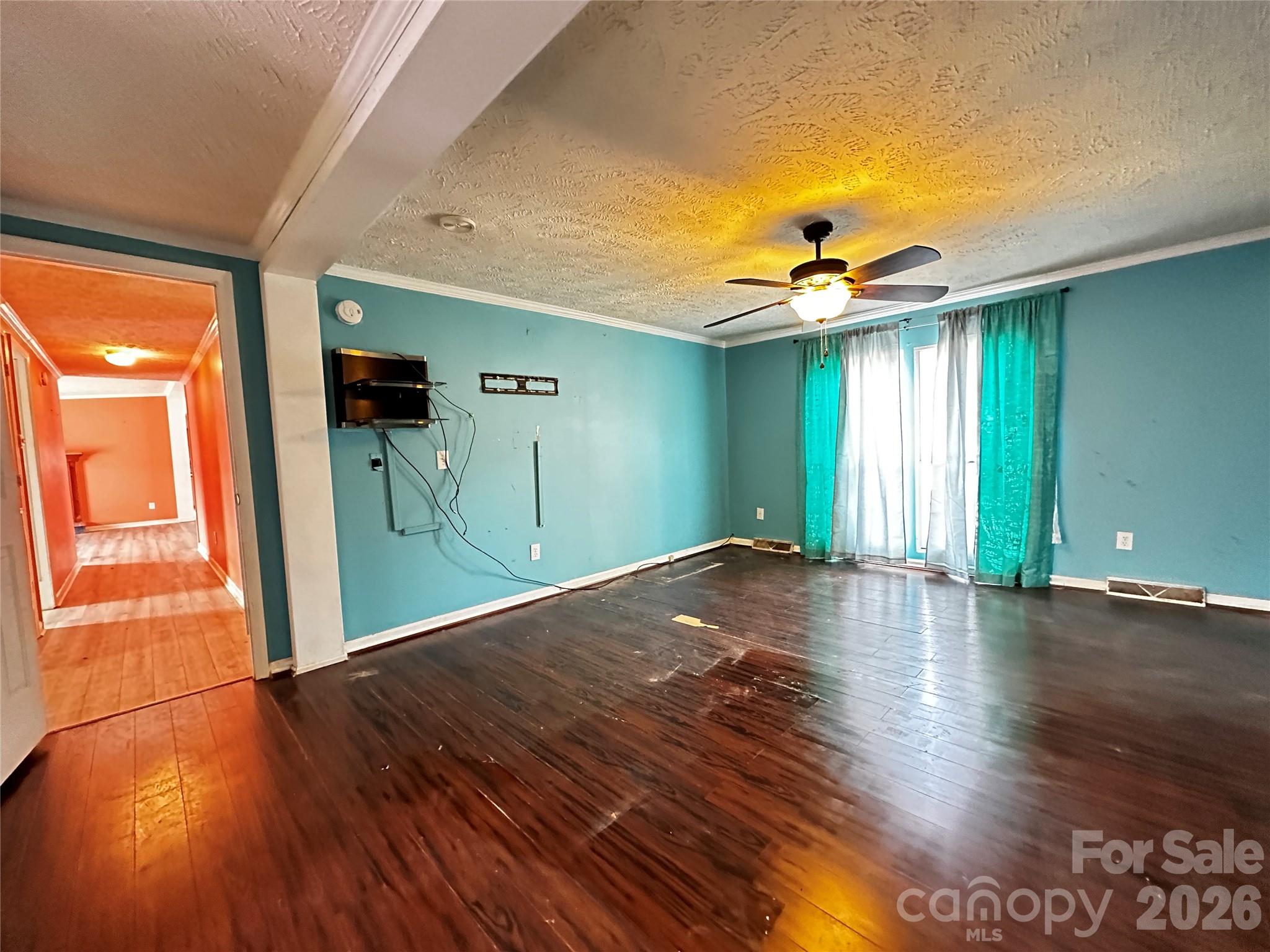 7447 Highway 64, Unit 2 Morganton, NC 28655 - Photo 15 of 27 a view of a livingroom with wooden floor and a ceiling fan