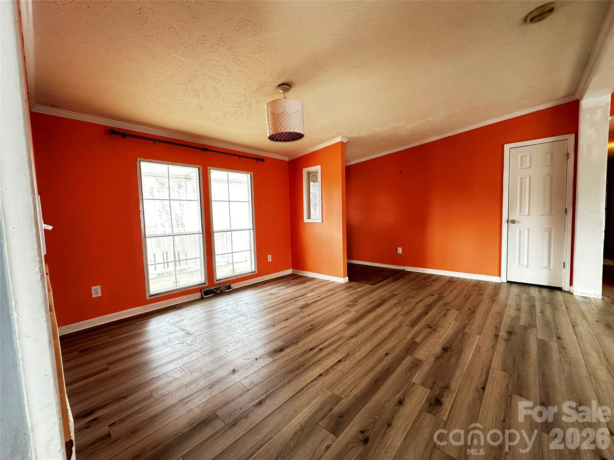 7447 Highway 64, Unit 2 Morganton, NC 28655 - Photo 16 of 27 a view of an empty room with wooden floor and a window
