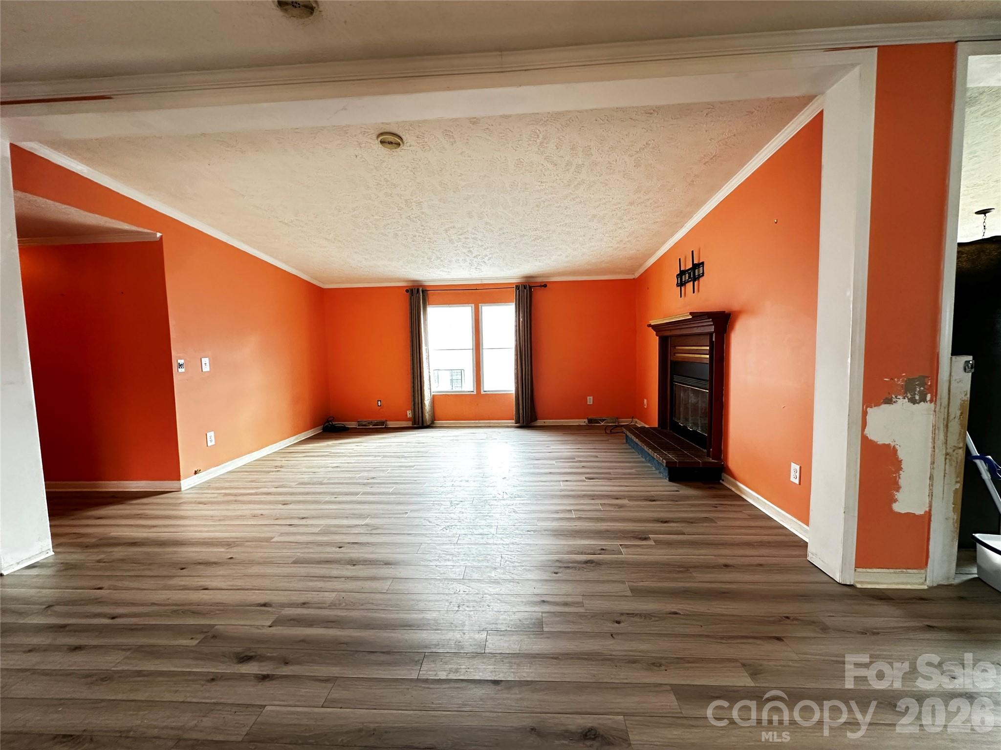 7447 Highway 64, Unit 2 Morganton, NC 28655 - Photo 17 of 27 a view of an empty room with wooden floor and a window