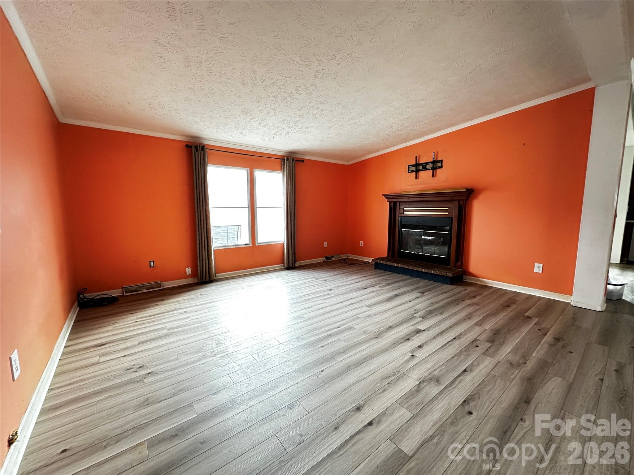 7447 Highway 64, Unit 2 Morganton, NC 28655 - Photo 18 of 27 an empty room with wooden floor and windows