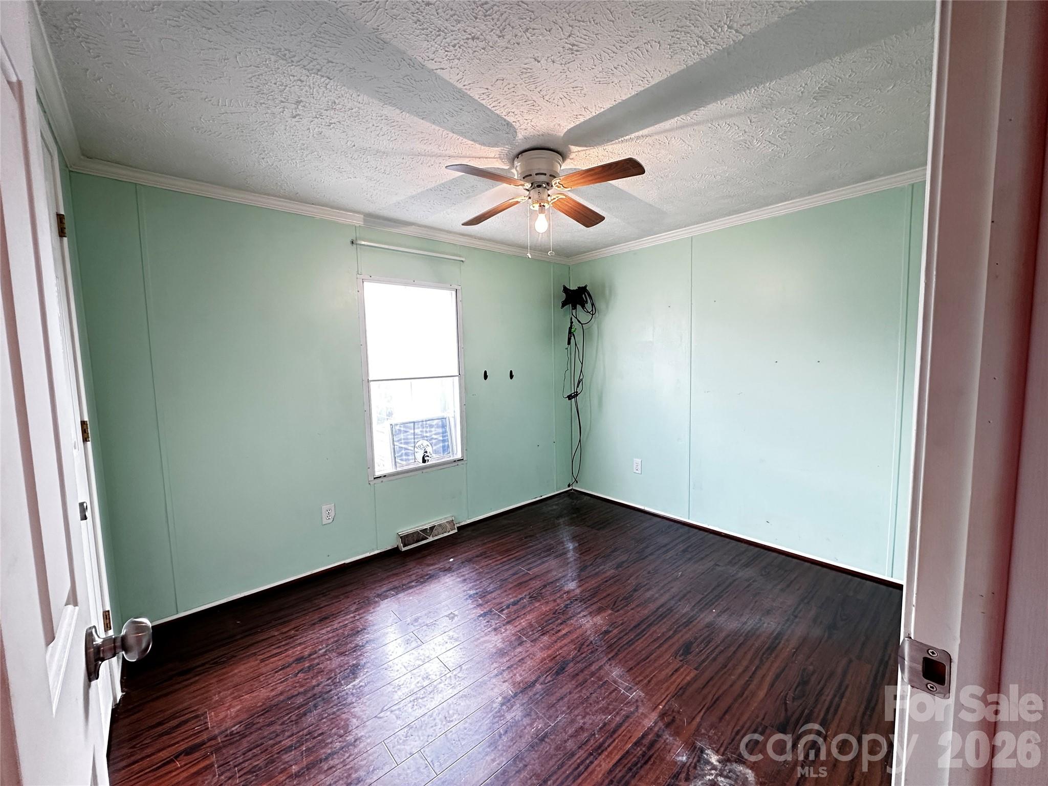 7447 Highway 64, Unit 2 Morganton, NC 28655 - Photo 20 of 27 an empty room with wooden floor fan and windows