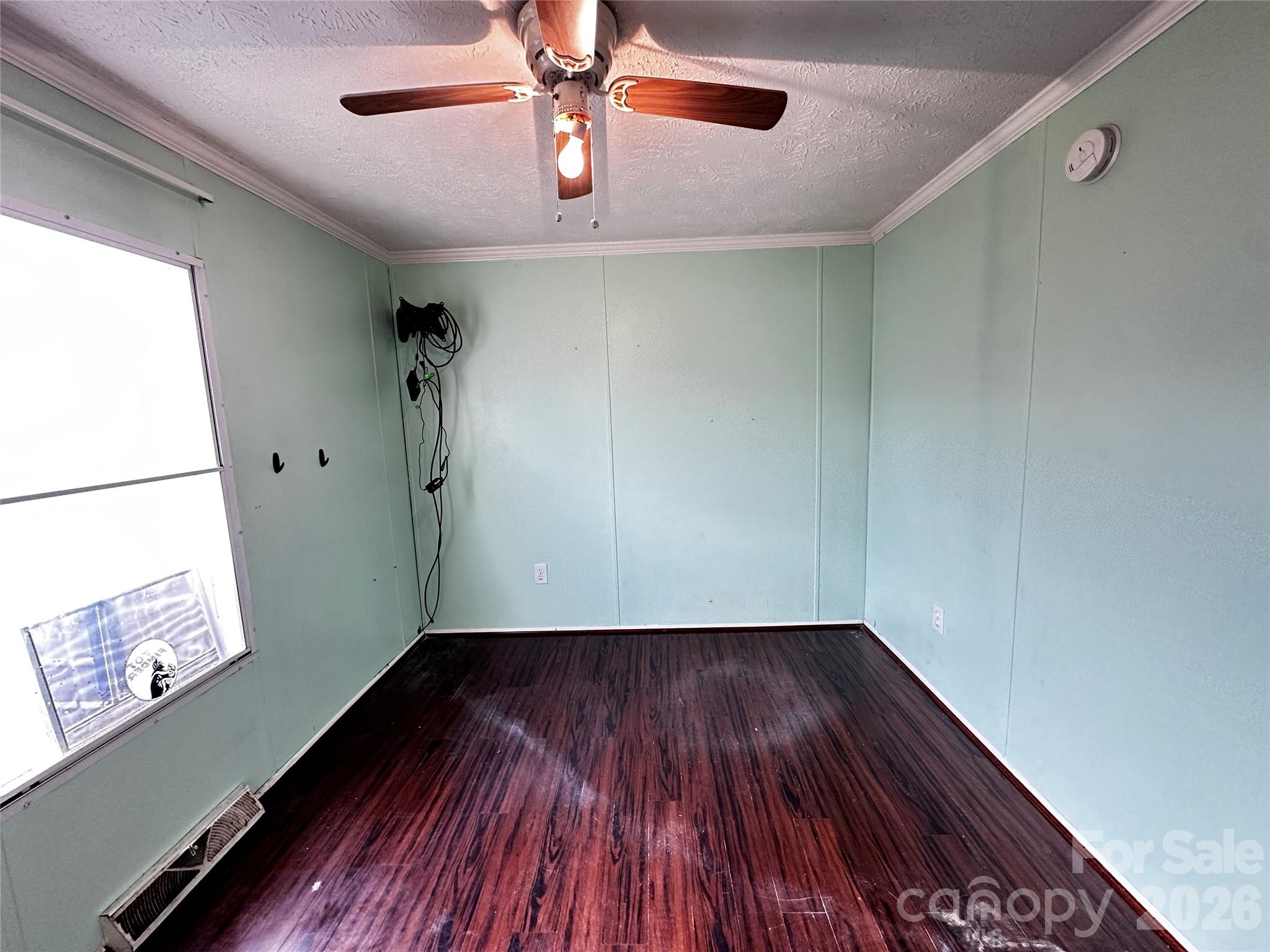 7447 Highway 64, Unit 2 Morganton, NC 28655 - Photo 21 of 27 a view of an empty room with wooden floor and a window
