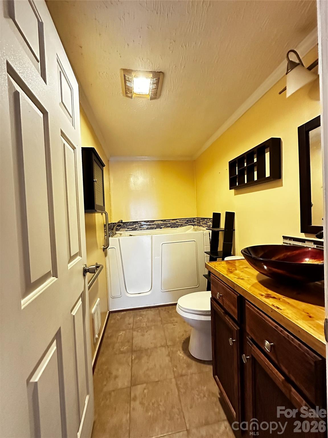 7447 Highway 64, Unit 2 Morganton, NC 28655 - Photo 22 of 27 a bathroom with a granite countertop sink and a toilet