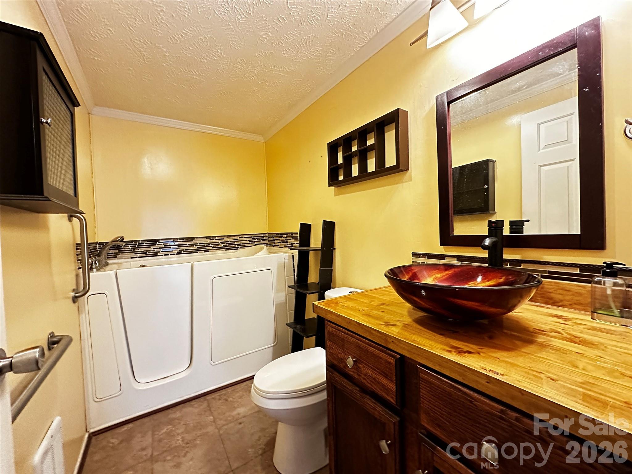 7447 Highway 64, Unit 2 Morganton, NC 28655 - Photo 23 of 27 a bathroom with a granite countertop sink and a mirror