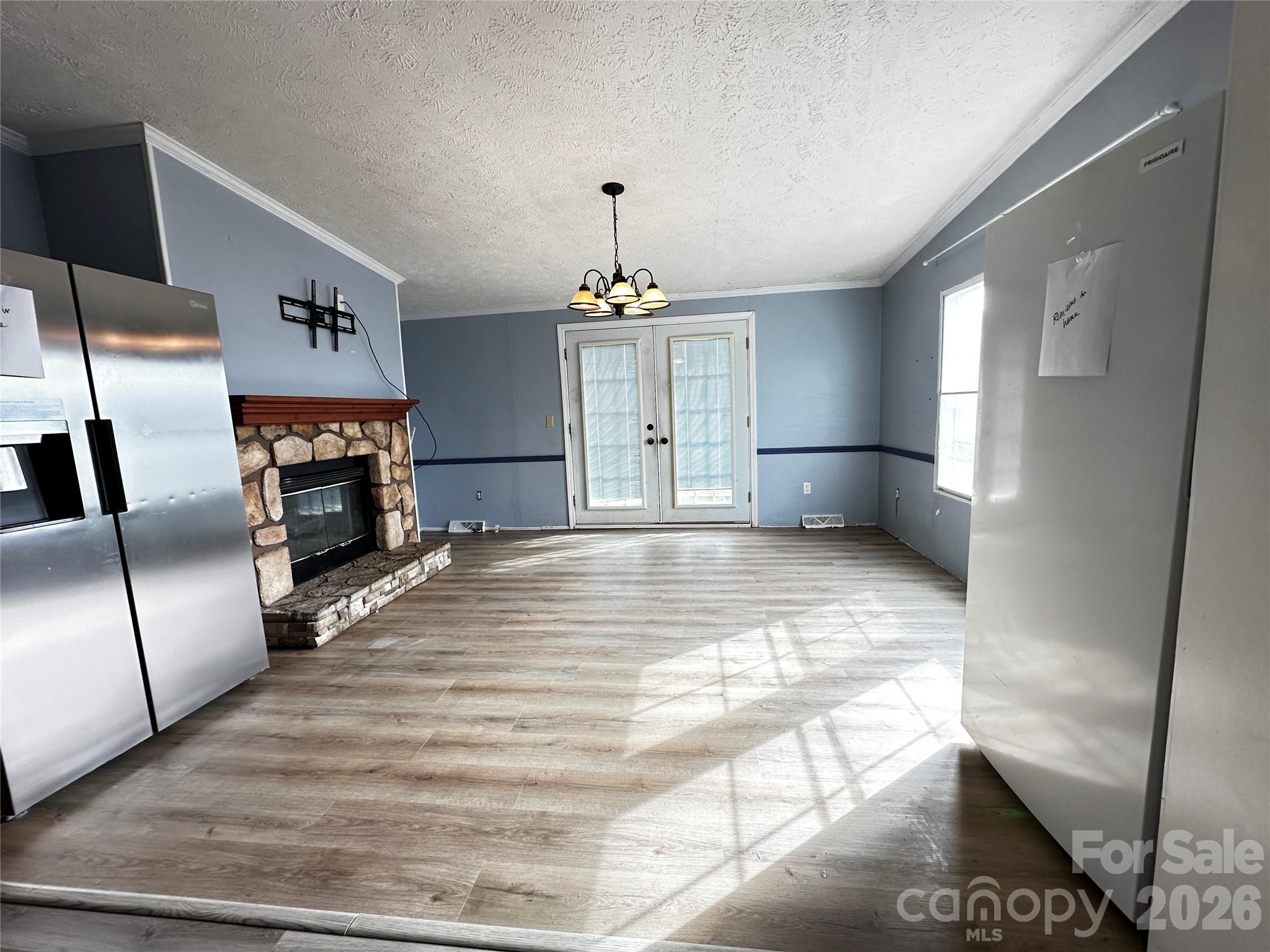 7447 Highway 64, Unit 2 Morganton, NC 28655 - Photo 5 of 27 a view of a kitchen with a sink a refrigerator and a fireplace