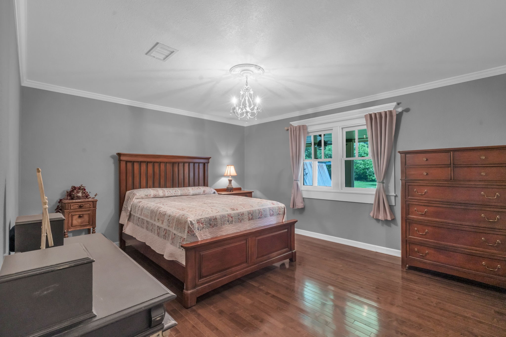 17821 Brown Road Conroe, TX 77306 - Photo 25 of 50 a bedroom with a bed and wooden floor