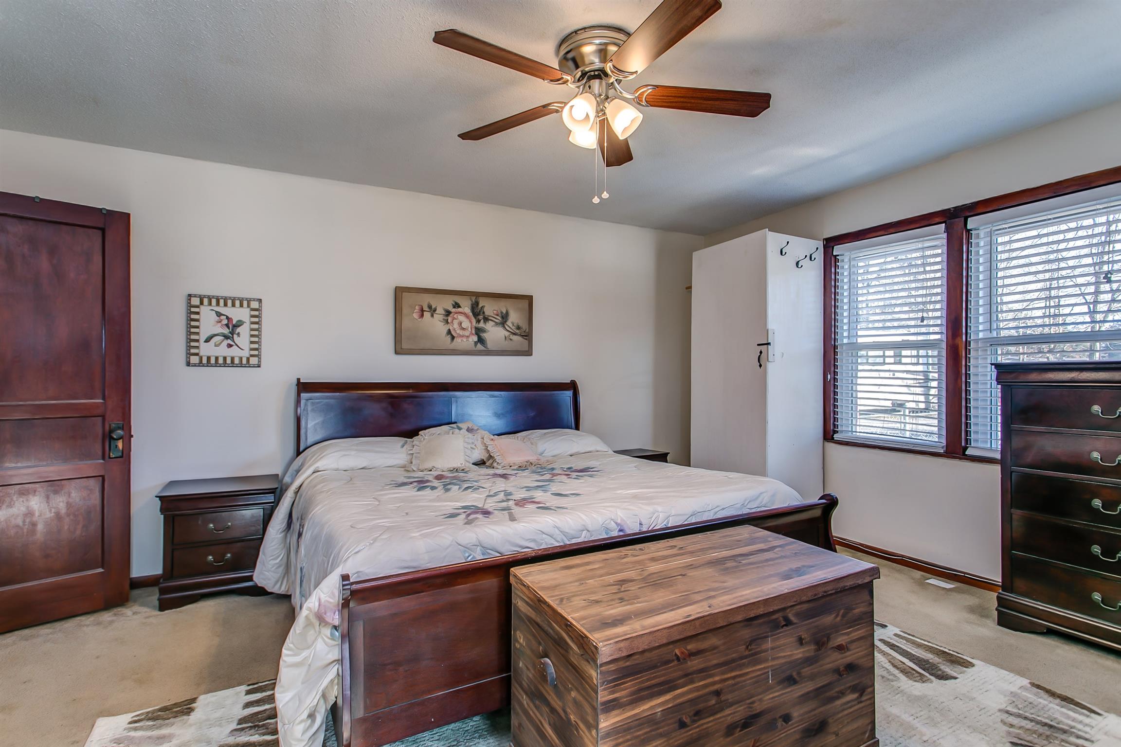 4227 Kedron Road Spring Hill, TN 37174 - Photo 7 of 13 a bedroom with a bed and a chandelier