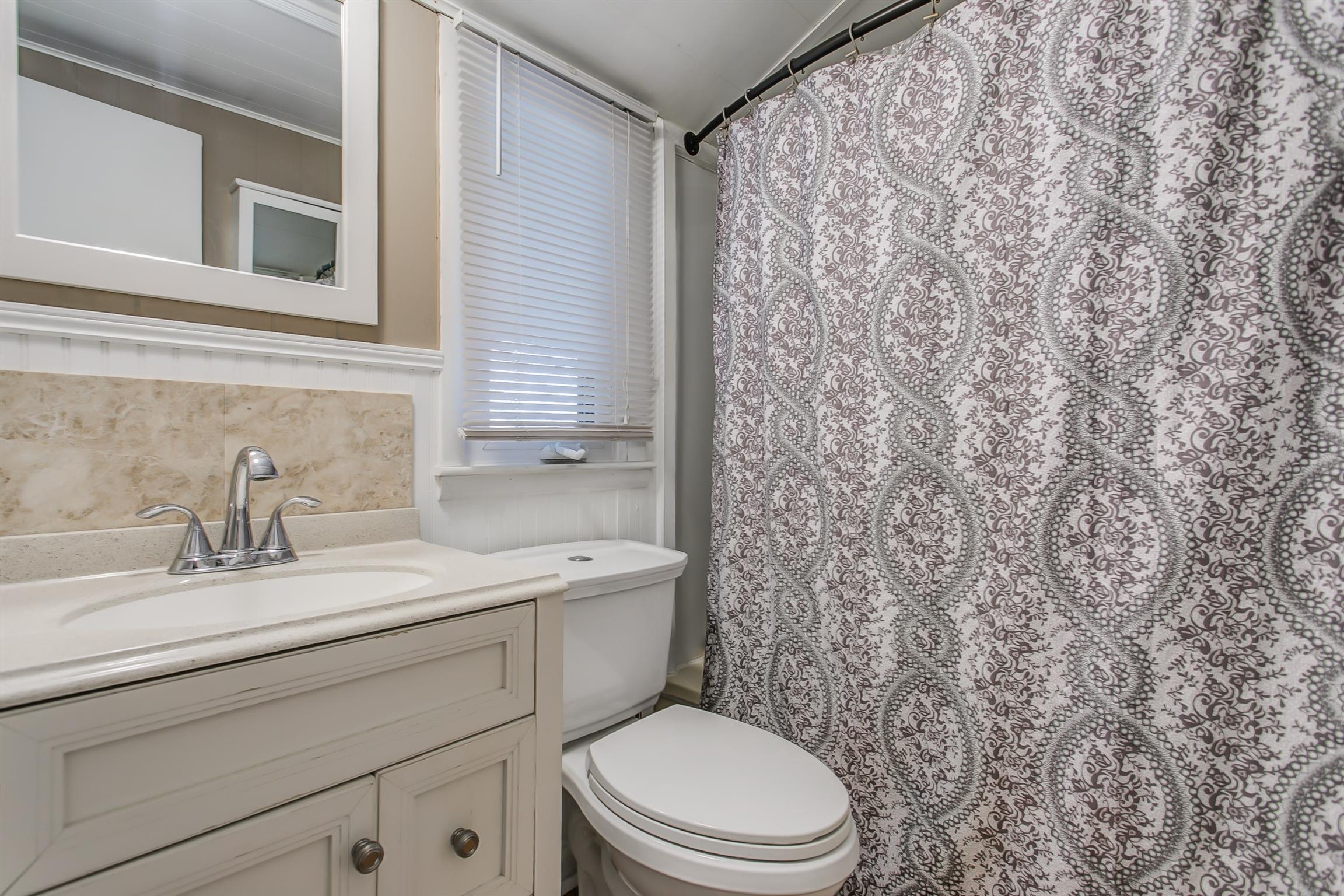 4227 Kedron Road Spring Hill, TN 37174 - Photo 8 of 13 a bathroom with a granite countertop sink toilet and mirror
