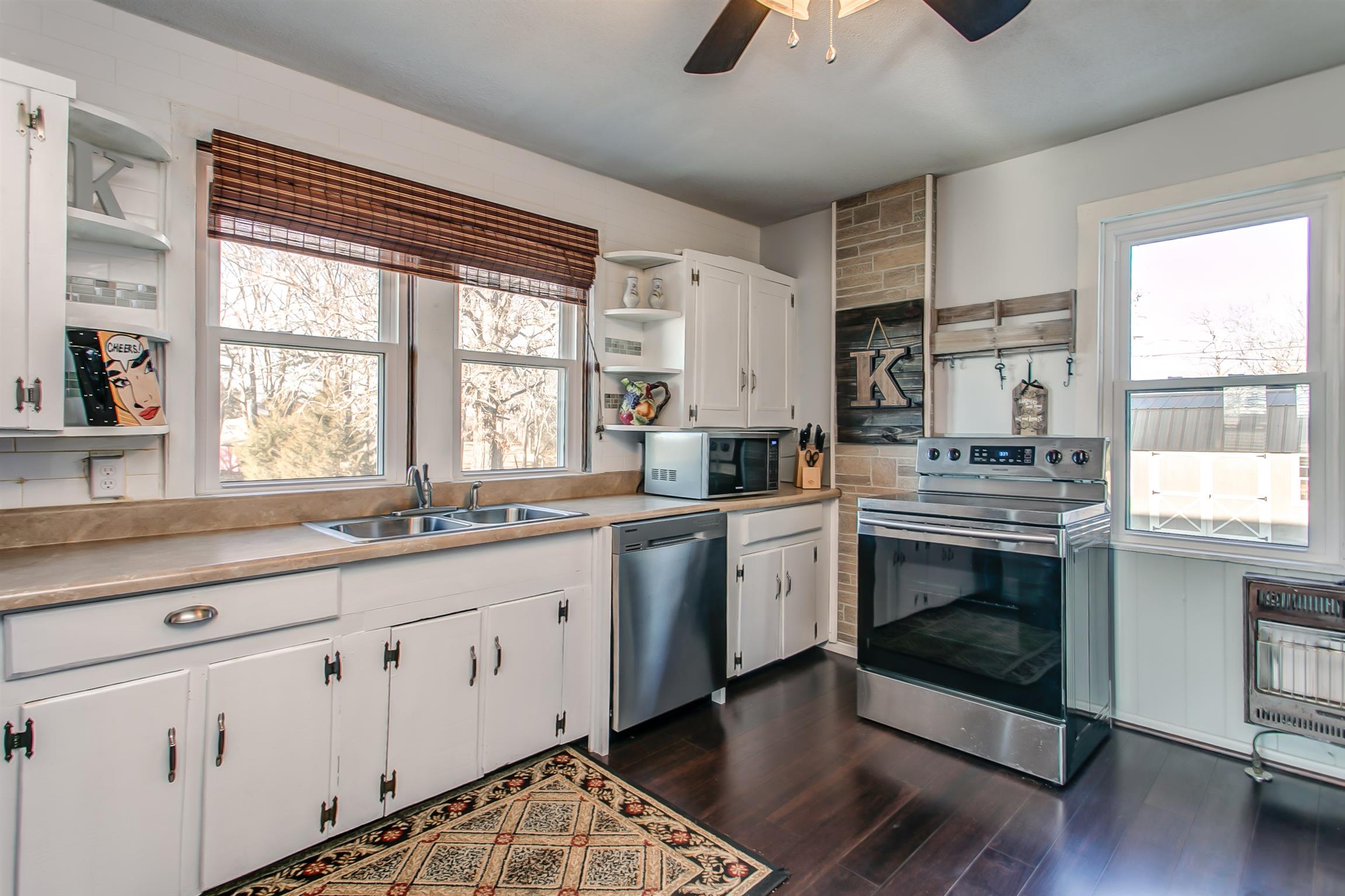 4227 Kedron Road Spring Hill, TN 37174 - Photo 9 of 13 a kitchen with stainless steel appliances a stove sink and cabinets