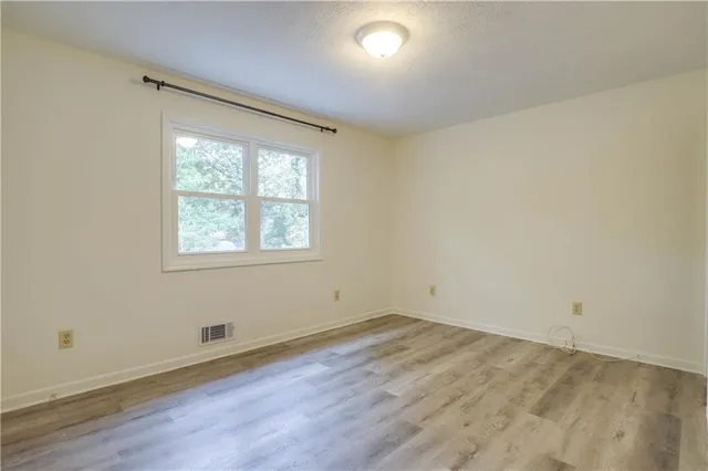 an empty room with wooden floor