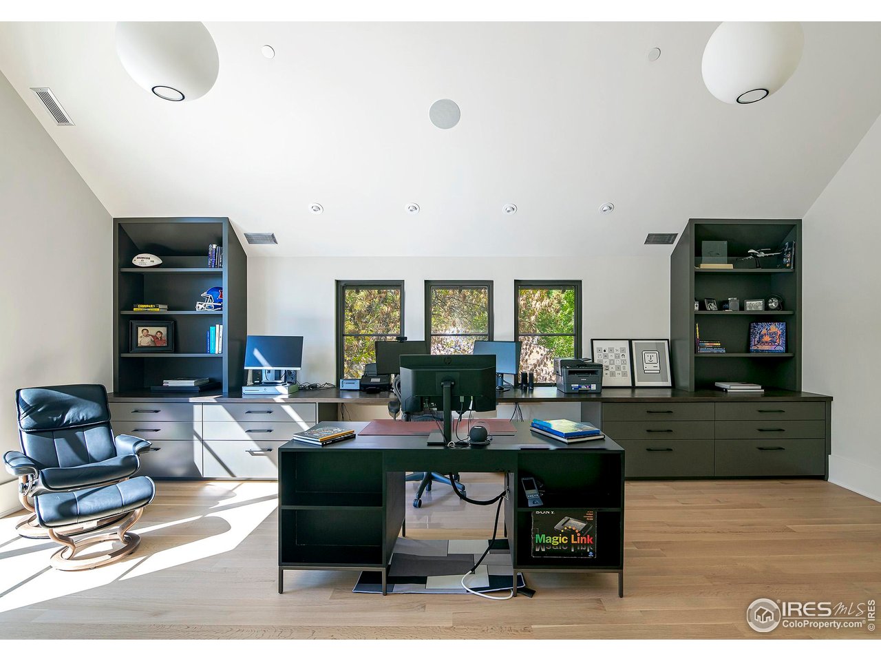 3621 21st Street Boulder, CO 80304 - Photo 36 of 50 The upper level office with custom cabinetry, white oak hardwood floors, vaulted ceilings, and private deck. This office is already equipped with plumbing for a bathroom, allowing for easy conversion into a fifth bedroom with an ensuite.
