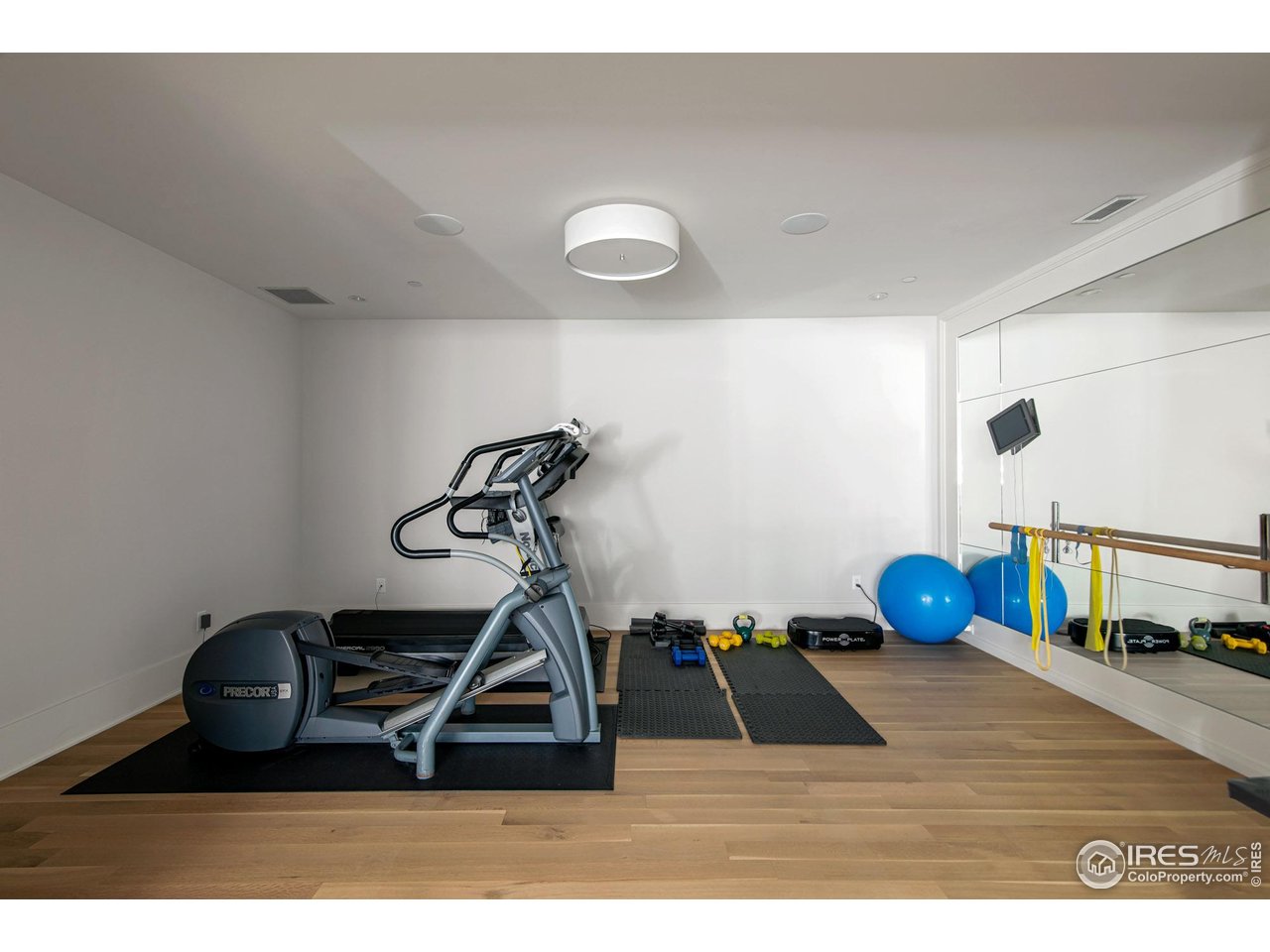 3621 21st Street Boulder, CO 80304 - Photo 40 of 50 Gym with hardwood floors, in ceiling speakers, barn doors and wall of mirrors