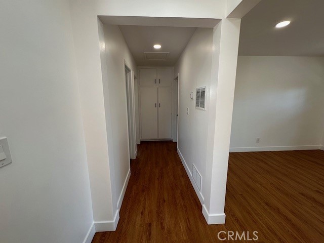 14621 1/2 Clark Street Baldwin Park, CA 91706 - Photo 11 of 28 a view of a hallway with wooden floor and staircase