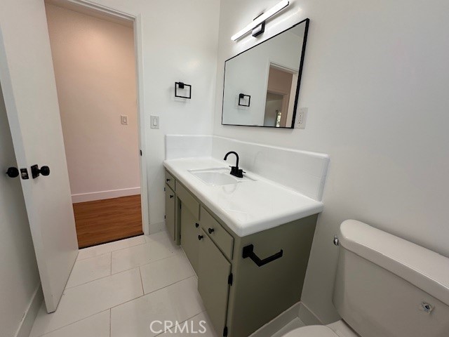14621 1/2 Clark Street Baldwin Park, CA 91706 - Photo 13 of 28 a bathroom with a sink a toilet and vanity