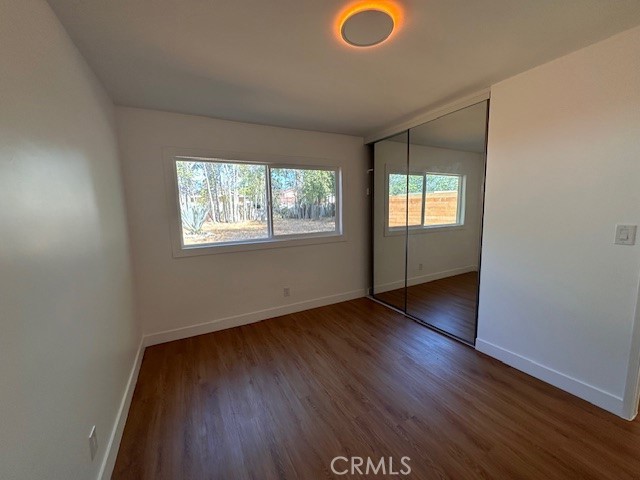 14621 1/2 Clark Street Baldwin Park, CA 91706 - Photo 14 of 28 an empty room with wooden floor and windows