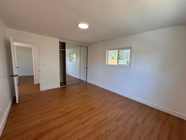 14621 1/2 Clark Street Baldwin Park, CA 91706 - Photo 15 of 28 an empty room with wooden floor and windows