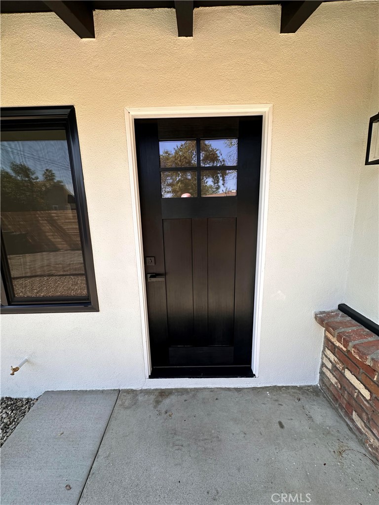 14621 1/2 Clark Street Baldwin Park, CA 91706 - Photo 3 of 28 a view of a hallway with wooden floor