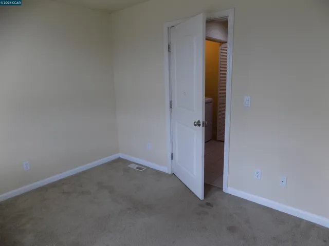 an empty room with closet and closet