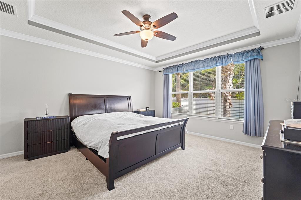 8903 Arabella Lane Seminole, FL 33777 - Photo 12 of 47 a bedroom with a large bed and a large window