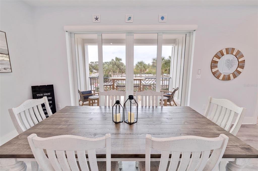 1800 Gulf Boulevard, Unit 1 Indian Rocks Beach, FL 33785 - Photo 27 of 97 a dining room with furniture wooden floor and a chandelier
