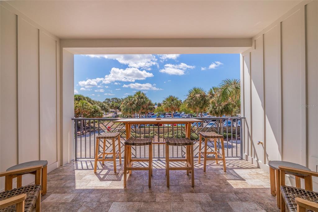1800 Gulf Boulevard, Unit 1 Indian Rocks Beach, FL 33785 - Photo 29 of 97 a view of a chairs and table in a balcony