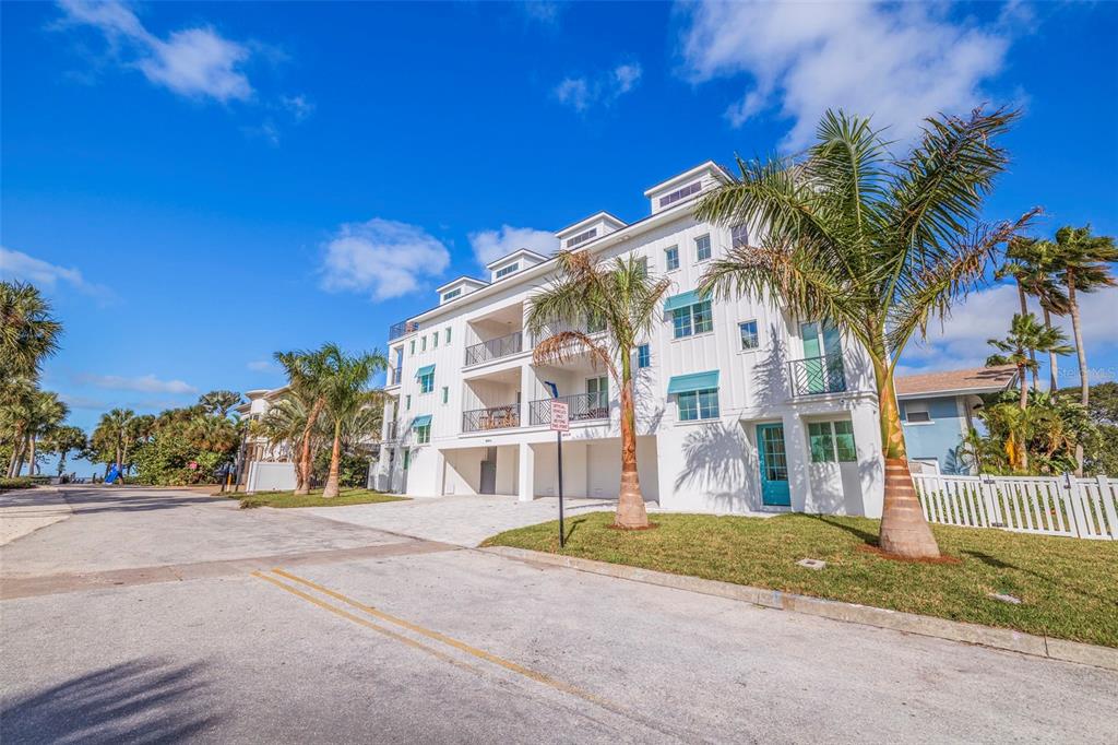 1800 Gulf Boulevard, Unit 1 Indian Rocks Beach, FL 33785 - Photo 68 of 97 a front view of a house with a yard and garage