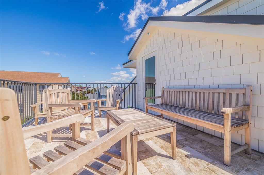 1800 Gulf Boulevard, Unit 1 Indian Rocks Beach, FL 33785 - Photo 80 of 97 a balcony with table and chairs