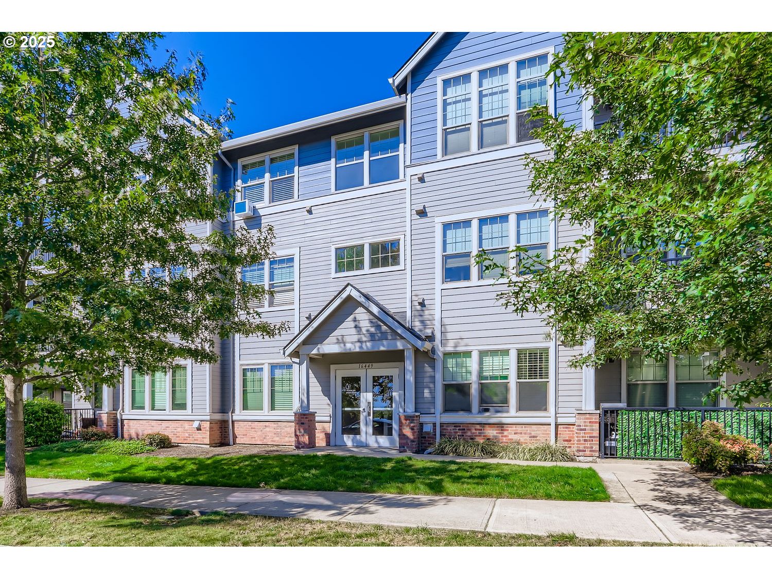 a front view of a house with a garden