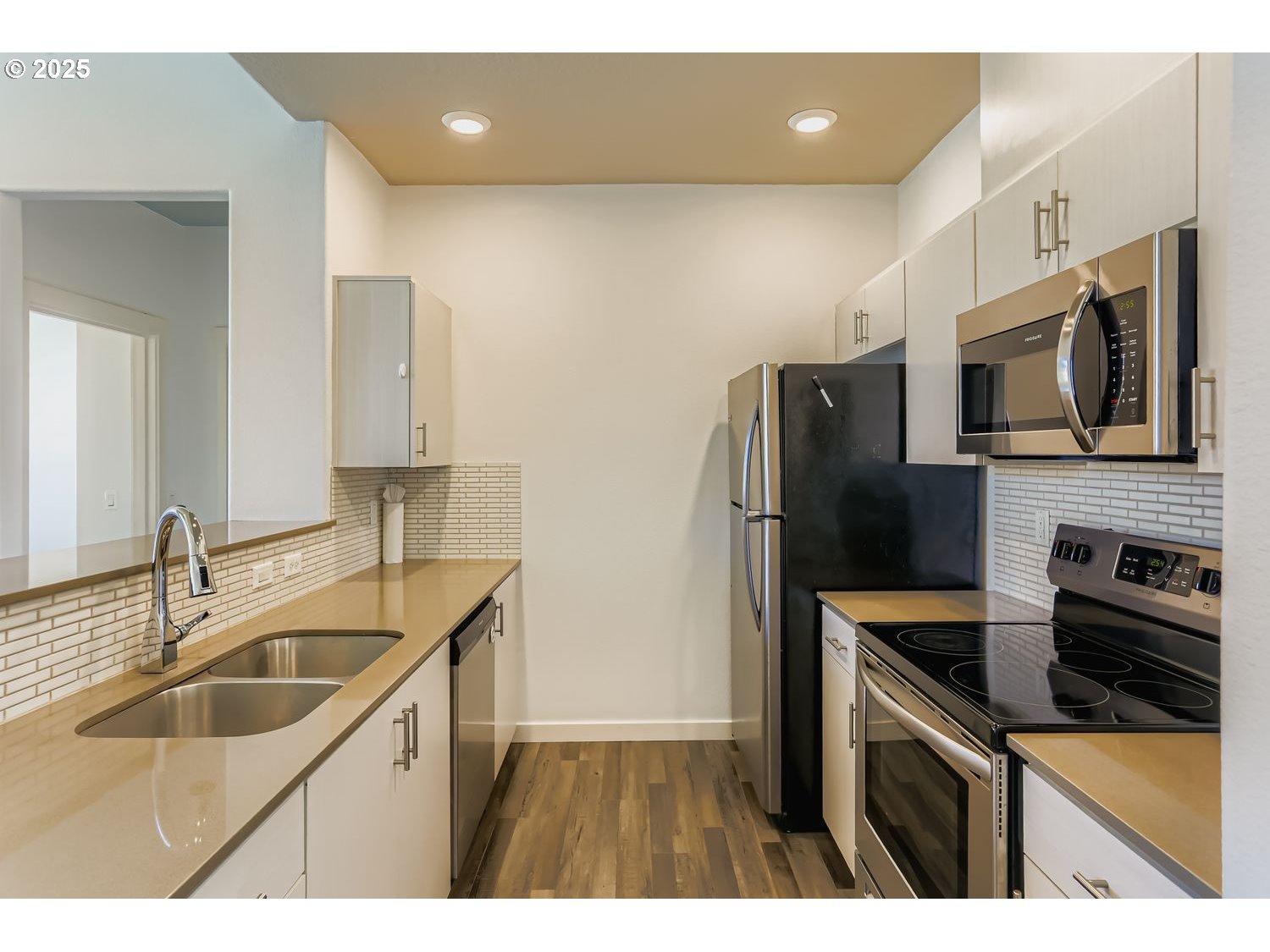 16449 Northwest Chadwick Way, Unit 305 Portland, OR 97229 - Photo 4 of 11 a kitchen that has a sink cabinets counter space stainless steel appliances and cabinets