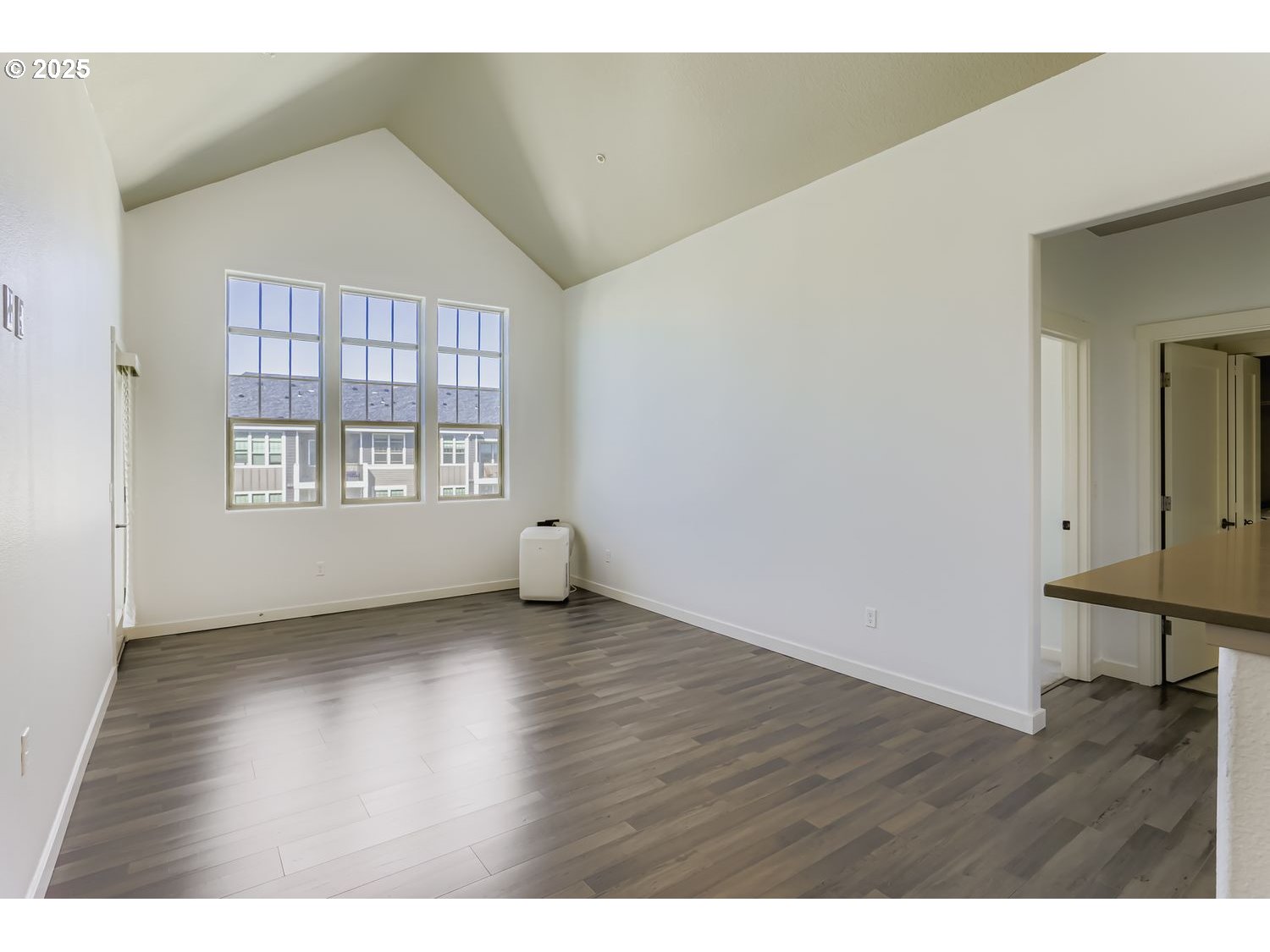 16449 Northwest Chadwick Way, Unit 305 Portland, OR 97229 - Photo 5 of 11 an empty room with wooden floor and windows