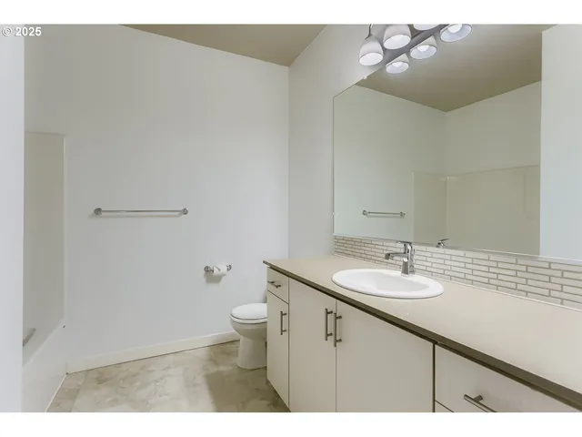 a bathroom with a sink a toilet and mirror