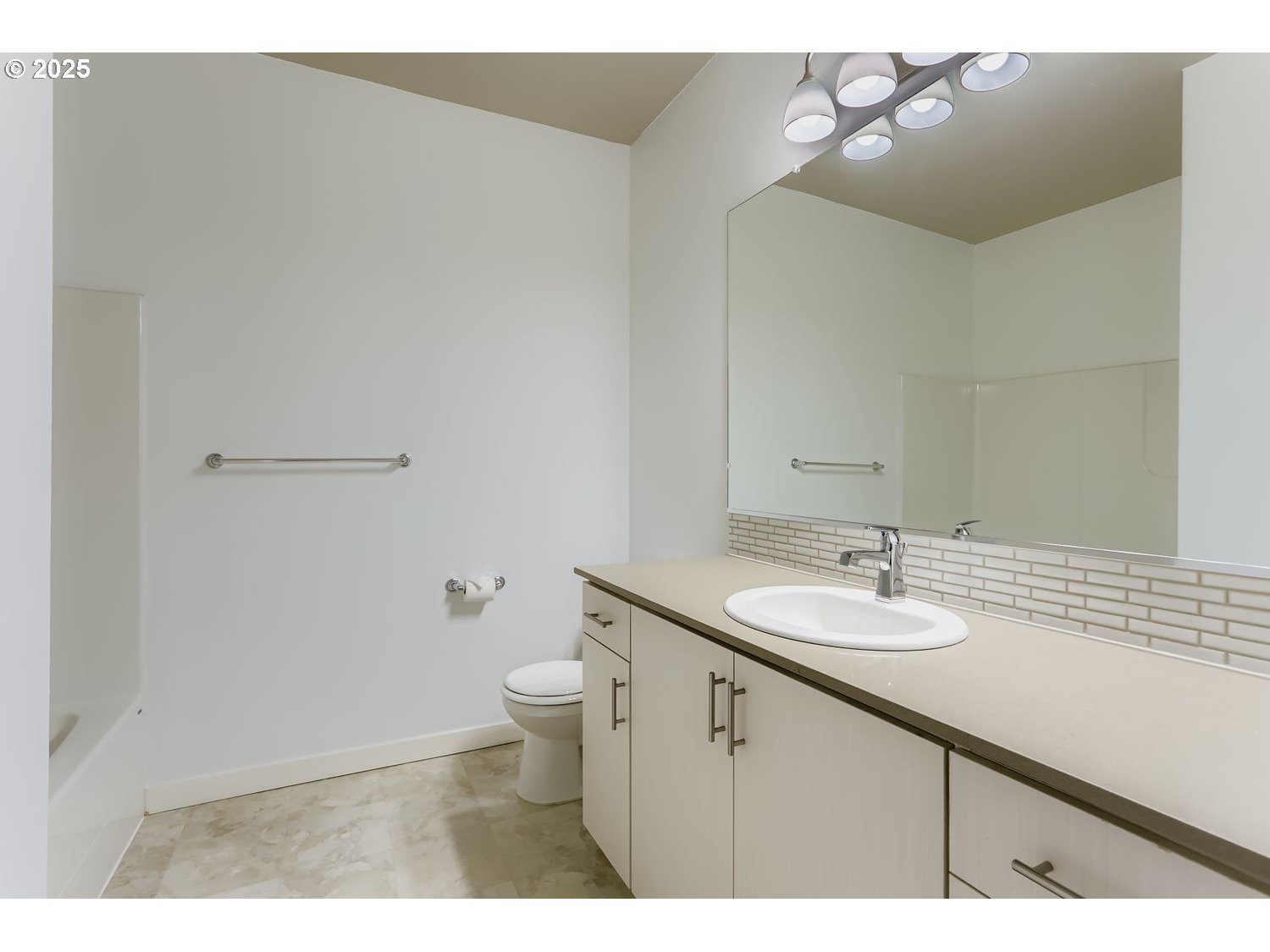 16449 Northwest Chadwick Way, Unit 305 Portland, OR 97229 - Photo 9 of 11 a bathroom with a sink a toilet and mirror