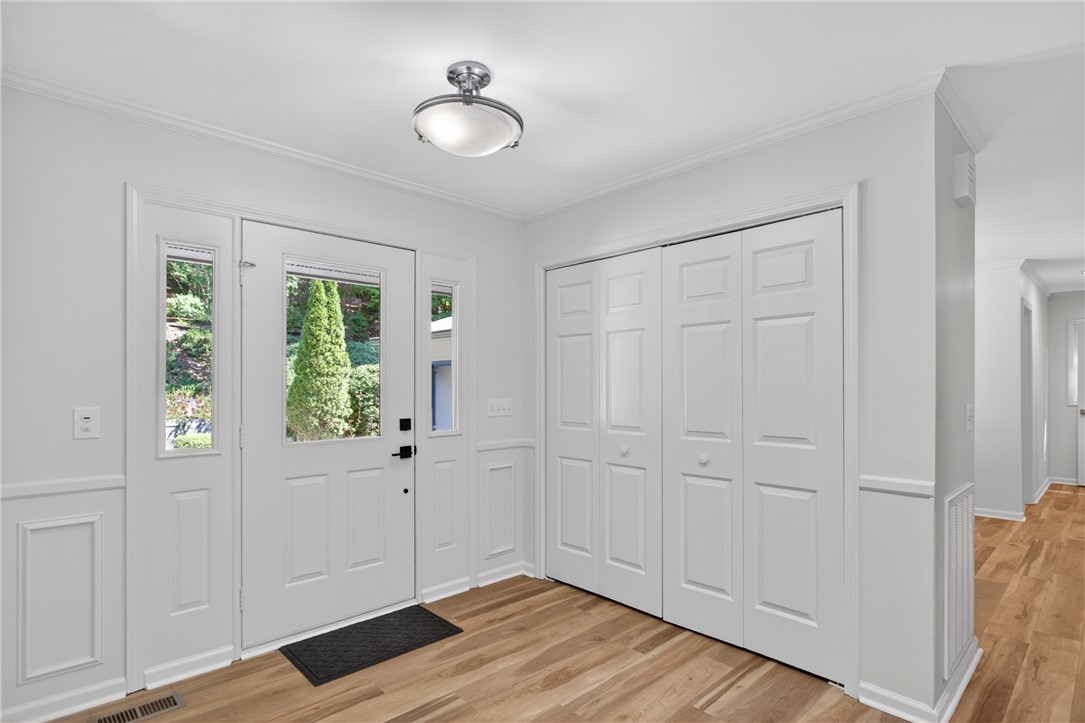 9 Lookout Lane Salem, SC 29676 - Photo 11 of 46 A welcoming entry features hardwood floors and crisp white trim, illuminated by a contemporary flush-mount light fixture.
