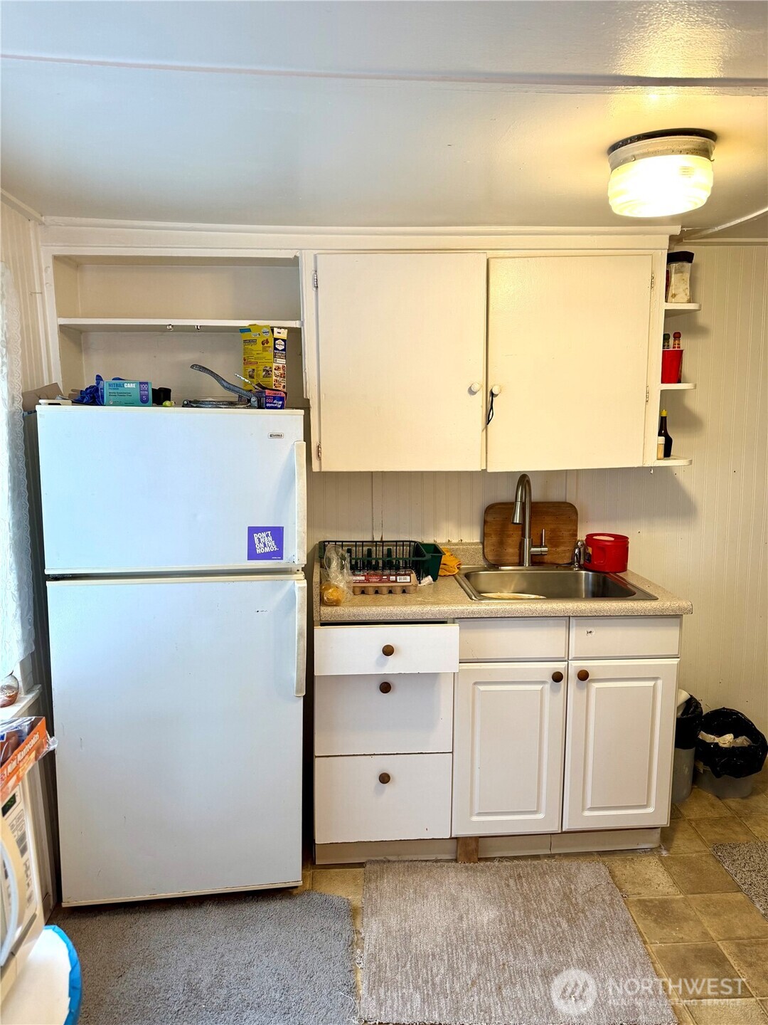 11040 11th Avenue Southwest Seattle, WA 98146 - Photo 12 of 18 a white refrigerator freezer sitting inside of a kitchen