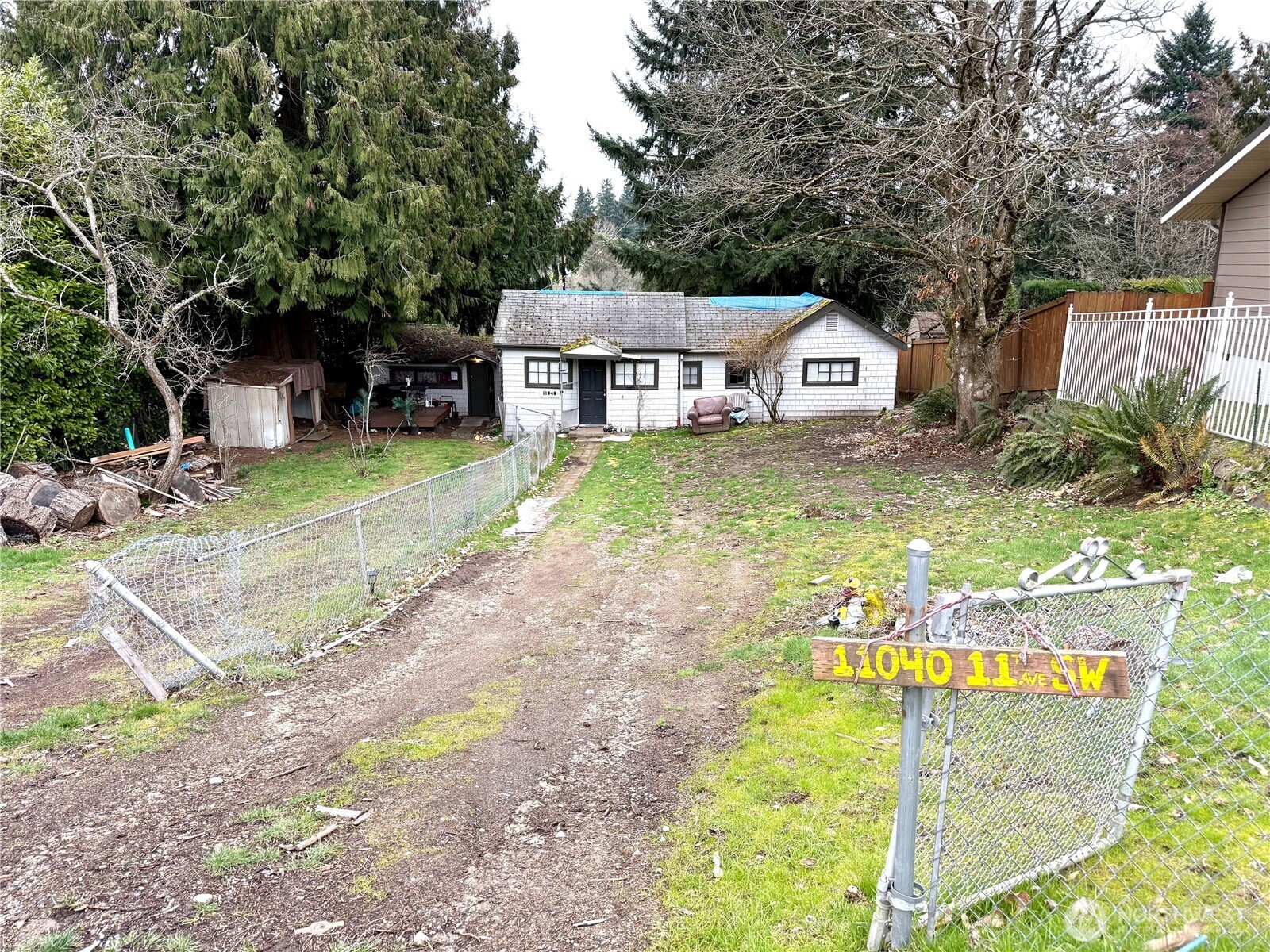 11040 11th Avenue Southwest Seattle, WA 98146 - Photo 18 of 18 a view of a house with big yard and large trees