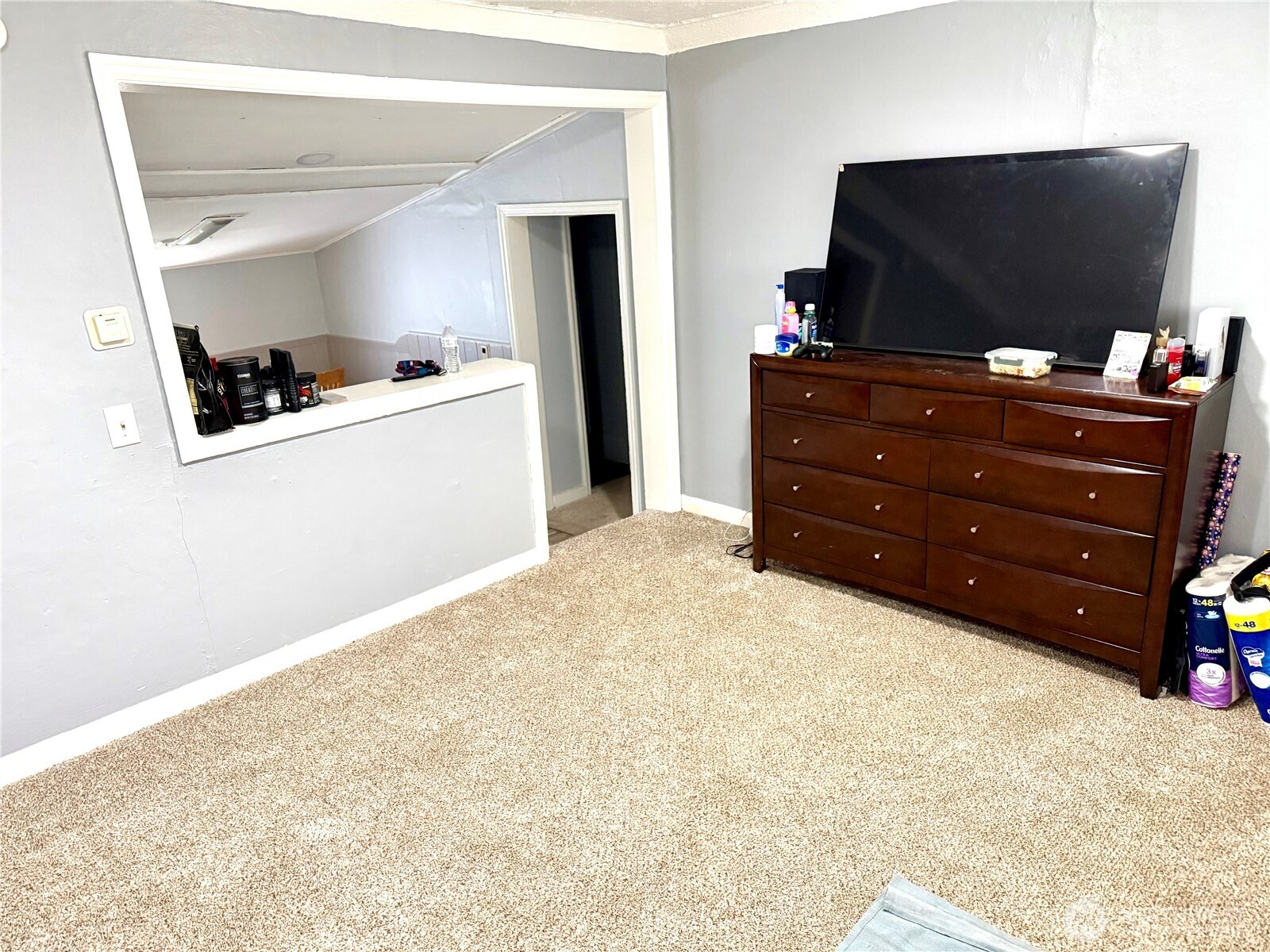 11040 11th Avenue Southwest Seattle, WA 98146 - Photo 3 of 18 a bedroom with a bed and flat screen tv