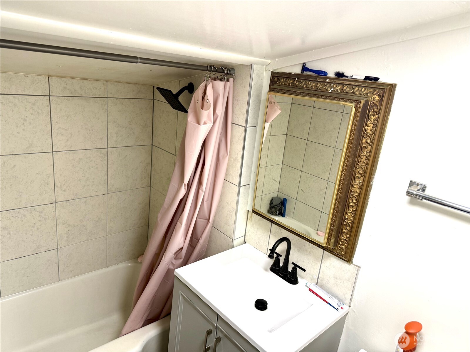 11040 11th Avenue Southwest Seattle, WA 98146 - Photo 8 of 18 a bathroom with a sink and a mirror