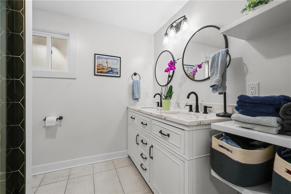 1654 Hollyrood Road Pittsburgh, PA 15227 - Photo 19 of 33 a bathroom with a sink a vanity and a mirror