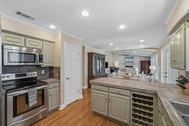a kitchen with a sink stainless steel appliances and cabinets