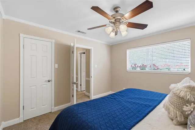 a bedroom with a large bed and a window