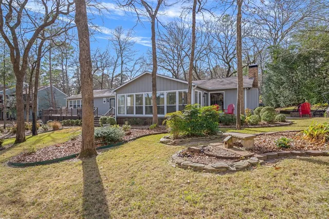 a view of a house with a yard covered in snow